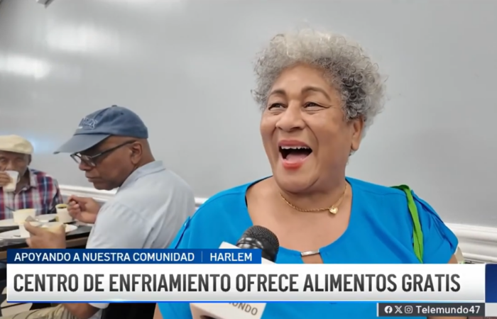 Senior smiling during an interview with Telemundo 47 at the Community Kitchen and Pantry in West Harlem.